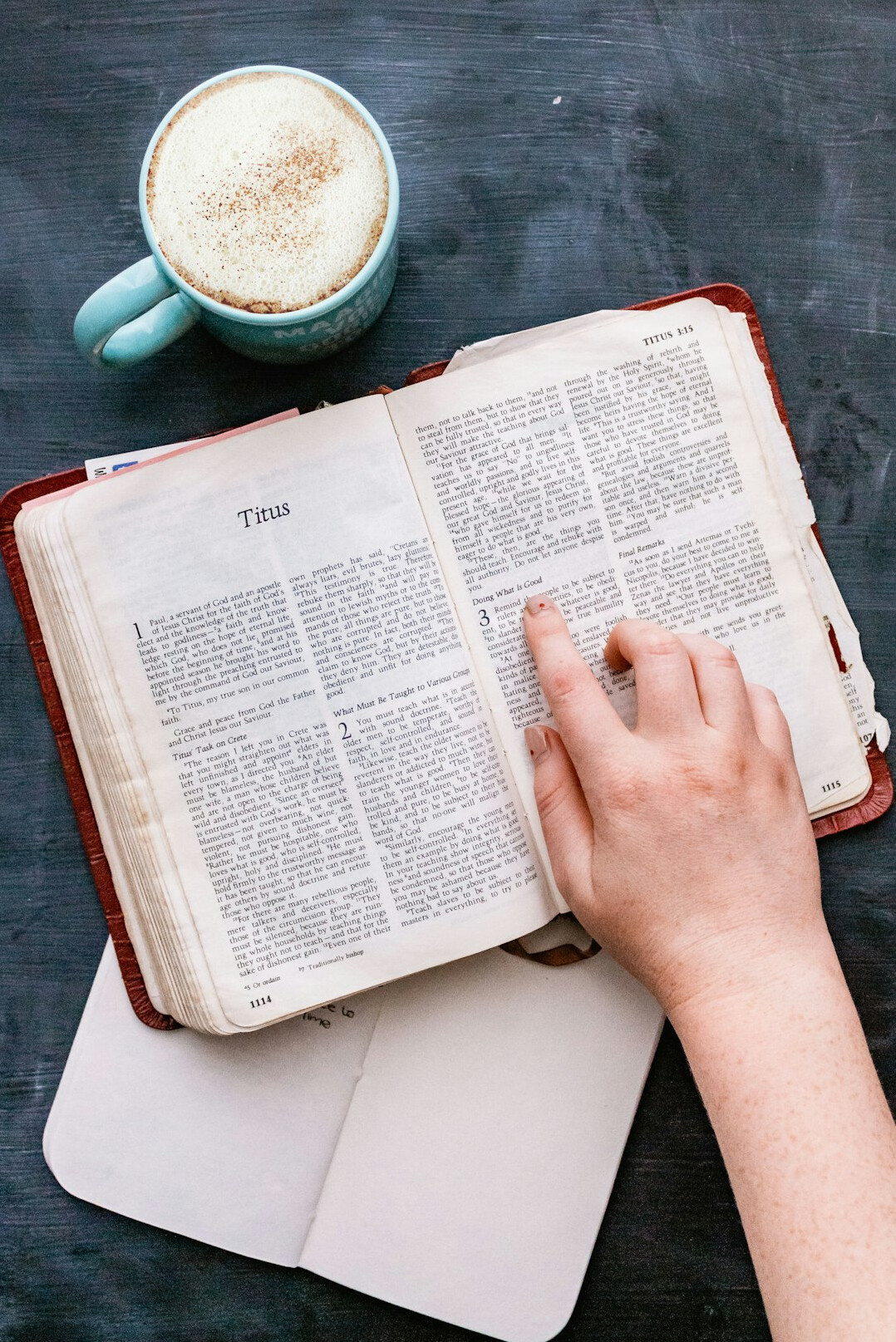 Hand writing notes in a notebook