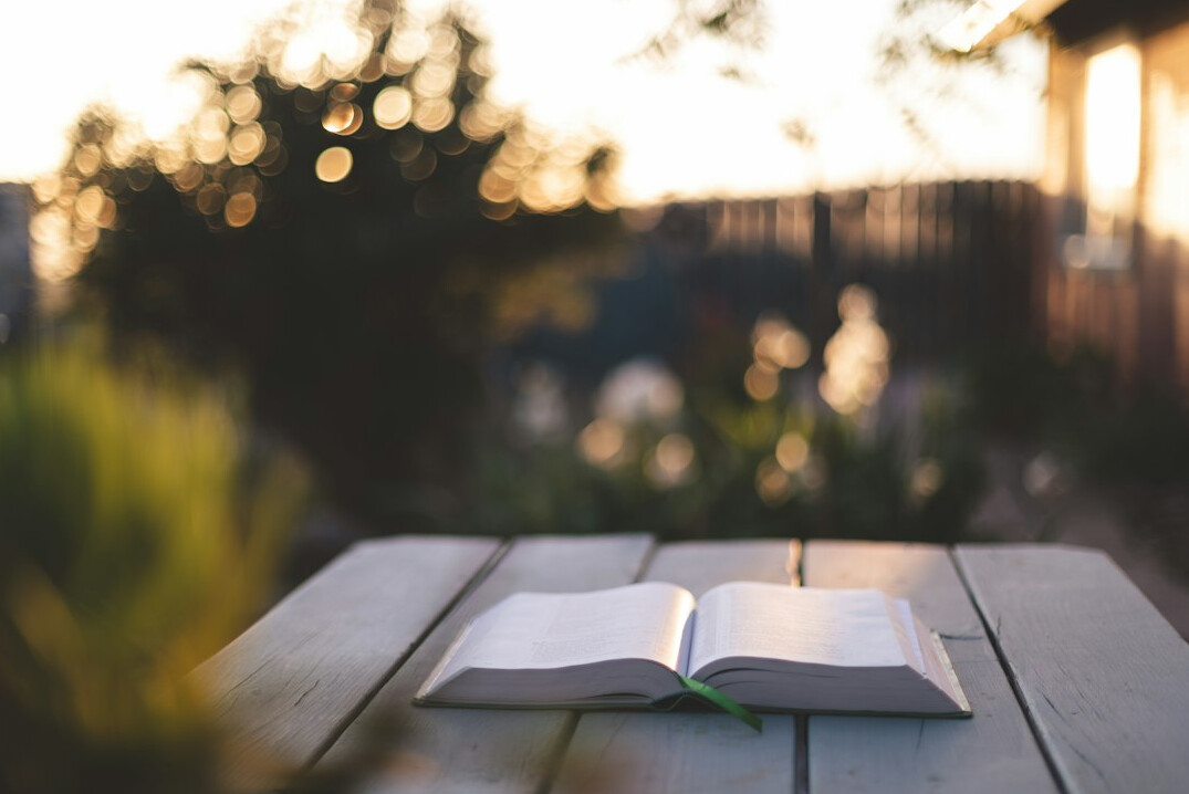 Open book on a table with warm light